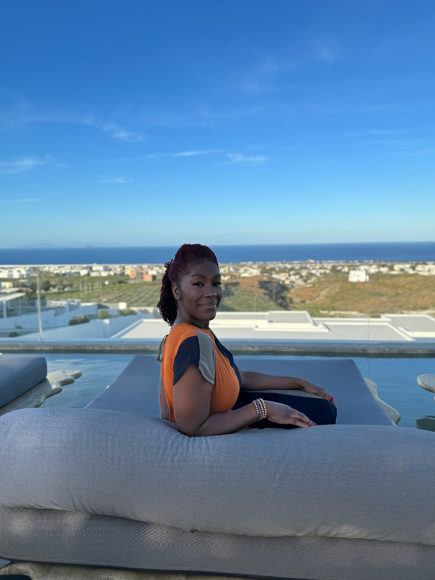 Banke Sotomi relaxing on a terrace overlooking the sea
